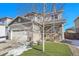 Lovely two-story home with a well-maintained lawn, decorative porch details, a two-car garage, and charming curb appeal at 7888 Tejon St, Denver, CO 80221