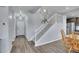 Home foyer featuring wood vinyl flooring, white trim staircase, and neutral color palette at 7888 Tejon St, Denver, CO 80221