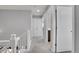 Hallway with neutral carpet, white doors, white trim, and gray colored walls at 7888 Tejon St, Denver, CO 80221