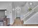 Open hallway with stairs, gray walls, hardwood floors, and access to multiple rooms at 7888 Tejon St, Denver, CO 80221