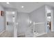 Upstairs hallway with neutral carpet, white trim, and two entryways into rooms at 7888 Tejon St, Denver, CO 80221