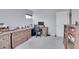 Bright home office with L-shaped wood desk, comfortable office chair, and built-in shelving at 7888 Tejon St, Denver, CO 80221