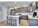 Modern kitchen features stainless steel appliances, gray cabinets, a center island, and stylish pendant lighting at 7888 Tejon St, Denver, CO 80221