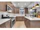 Modern kitchen with stainless steel appliances and an island at 7888 Tejon St, Denver, CO 80221