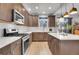 Stylish kitchen with an island, stainless steel appliances, modern lighting, and ample counter space at 7888 Tejon St, Denver, CO 80221