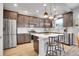 Modern kitchen with stainless steel appliances, subway tile backsplash, and center island with seating at 7888 Tejon St, Denver, CO 80221