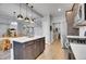 Modern kitchen with island, stainless steel appliances, and hardwood floors at 7888 Tejon St, Denver, CO 80221