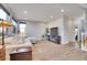 Cozy living area showcasing a plush sofa, wooden accents, and a staircase, blending modern design with comfort at 7888 Tejon St, Denver, CO 80221