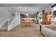 Bright and open living space with dining area, featuring hardwood floors and a staircase, connecting living areas at 7888 Tejon St, Denver, CO 80221