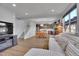 Open-concept living space with dining area, dark wood kitchen, and a comfortable sofa, ideal for entertaining at 7888 Tejon St, Denver, CO 80221