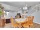 Spacious living room with dining table and view of stairs, offering a bright and open living space at 7888 Tejon St, Denver, CO 80221