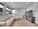 Bright living room with hardwood floors, a plush sectional sofa, and a modern entertainment center, perfect for relaxing at 7888 Tejon St, Denver, CO 80221