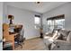 Cozy home office with a desk, comfortable seating, natural light, and laminate wood flooring at 7888 Tejon St, Denver, CO 80221