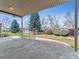 A covered back patio overlooks a large yard with mature trees at 1185 S Kramer Ct, Aurora, CO 80012