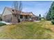 Large backyard with a covered patio area, ideal for outdoor activities at 1185 S Kramer Ct, Aurora, CO 80012