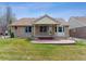 A lush backyard featuring a covered patio, offering a serene outdoor living space at 1185 S Kramer Ct, Aurora, CO 80012