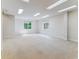 Finished basement with two windows for natural light, recessed lighting and plush carpeting at 1185 S Kramer Ct, Aurora, CO 80012