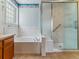 Bright bathroom featuring a tub and separate shower area with a glass enclosure at 1185 S Kramer Ct, Aurora, CO 80012
