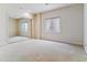 Bedroom with natural light, plush carpeting, and mirrored closet doors for added space at 1185 S Kramer Ct, Aurora, CO 80012