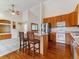 Open kitchen with hardwood floors, stainless steel appliances, and breakfast bar at 1185 S Kramer Ct, Aurora, CO 80012