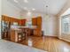 Well-lit kitchen featuring hardwood floors, stainless steel appliances, and breakfast bar at 1185 S Kramer Ct, Aurora, CO 80012
