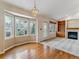 Open-concept dining area with hardwood floors, bay window, and built-in bookcase at 1185 S Kramer Ct, Aurora, CO 80012