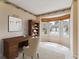Bright office space with bay window, wooden desk, and built-in bookshelves at 1185 S Kramer Ct, Aurora, CO 80012