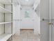 Spacious walk-in closet with lots of built in shelving, hanging rods, and natural light at 1185 S Kramer Ct, Aurora, CO 80012