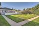 Spacious backyard showcasing a well-kept lawn, white fence, and mature trees providing privacy at 1279 Leyden St, Denver, CO 80220