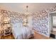 Bright bedroom with floral wallpaper, hardwood floors, chandelier, and a comfortable bed at 1279 Leyden St, Denver, CO 80220