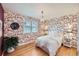 Cozy bedroom featuring hardwood floors, a chandelier and bright accents at 1279 Leyden St, Denver, CO 80220