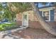 Close-up of the brick home's entry featuring a well-lit, traditional-style glass front door at 1279 Leyden St, Denver, CO 80220