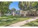 Charming brick home featuring a well-maintained lawn and a traditional design with blue shutters at 1279 Leyden St, Denver, CO 80220