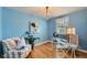 Bright office space with light blue walls, hardwood floors, and modern crystal chandelier and glass desk at 1279 Leyden St, Denver, CO 80220