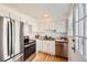 Efficient kitchen boasting stainless steel appliances, white cabinets, and hardwood flooring at 1279 Leyden St, Denver, CO 80220