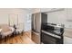 Modern kitchen featuring stainless steel appliances, hardwood floors, and a cozy breakfast nook at 1279 Leyden St, Denver, CO 80220