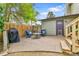 Outdoor patio with table and cushioned seating, a fenced yard, and stairs to the upper level at 16025 E Warren Pl, Aurora, CO 80013