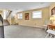 Finished basement featuring updated carpet, lighting, and staircase with black metal railing at 16025 E Warren Pl, Aurora, CO 80013