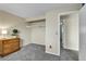 Bedroom featuring a wooden dresser, neutral walls, and a closet with hanging rack at 16025 E Warren Pl, Aurora, CO 80013
