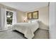 A bright bedroom features a large window, neutral walls, carpet, and space for a king bed at 16025 E Warren Pl, Aurora, CO 80013