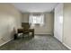 Bedroom with neutral walls, gray carpet, white trim, and a window providing natural light at 16025 E Warren Pl, Aurora, CO 80013