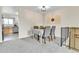 An inviting dining room features modern decor, carpeted floor, and easy access to the kitchen at 16025 E Warren Pl, Aurora, CO 80013