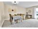 Welcoming dining room featuring gray carpet, decorative wall art, and a table set for four at 16025 E Warren Pl, Aurora, CO 80013