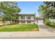Charming two-story home with a well-manicured lawn, attached garage, and inviting curb appeal at 16025 E Warren Pl, Aurora, CO 80013