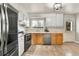 This kitchen features stainless steel appliances, a double oven, wood cabinets and an outdoor-facing window at 16025 E Warren Pl, Aurora, CO 80013