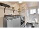 Laundry room featuring stainless steel washer and dryer, with a walk-in shower to the right at 16025 E Warren Pl, Aurora, CO 80013