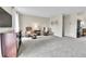 Spacious living room featuring plush carpet, comfortable seating, and neutral decor at 16025 E Warren Pl, Aurora, CO 80013