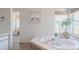 Relaxing bathroom with a jetted tub, tiled floors, and serene decor at 18155 Flowered Meadow Ln, Monument, CO 80132