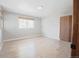 This bedroom features clean white walls and a wooden floor, with a window providing light to the living space at 18155 Flowered Meadow Ln, Monument, CO 80132