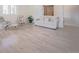 Bright living room with light wood floors, seating and large windows creating an airy and comfortable space at 18155 Flowered Meadow Ln, Monument, CO 80132